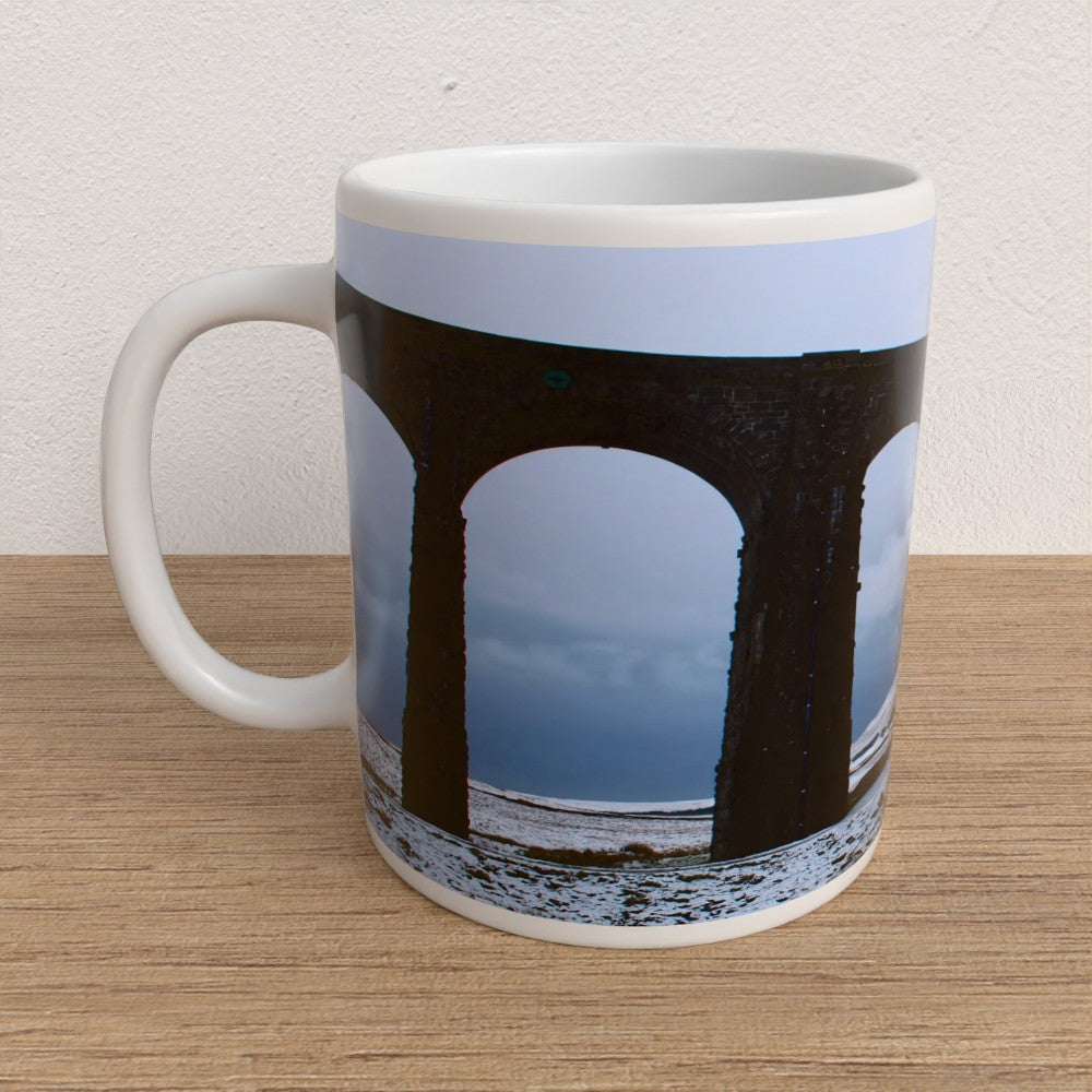 Mug with a design of a bridge on a wooden surface
