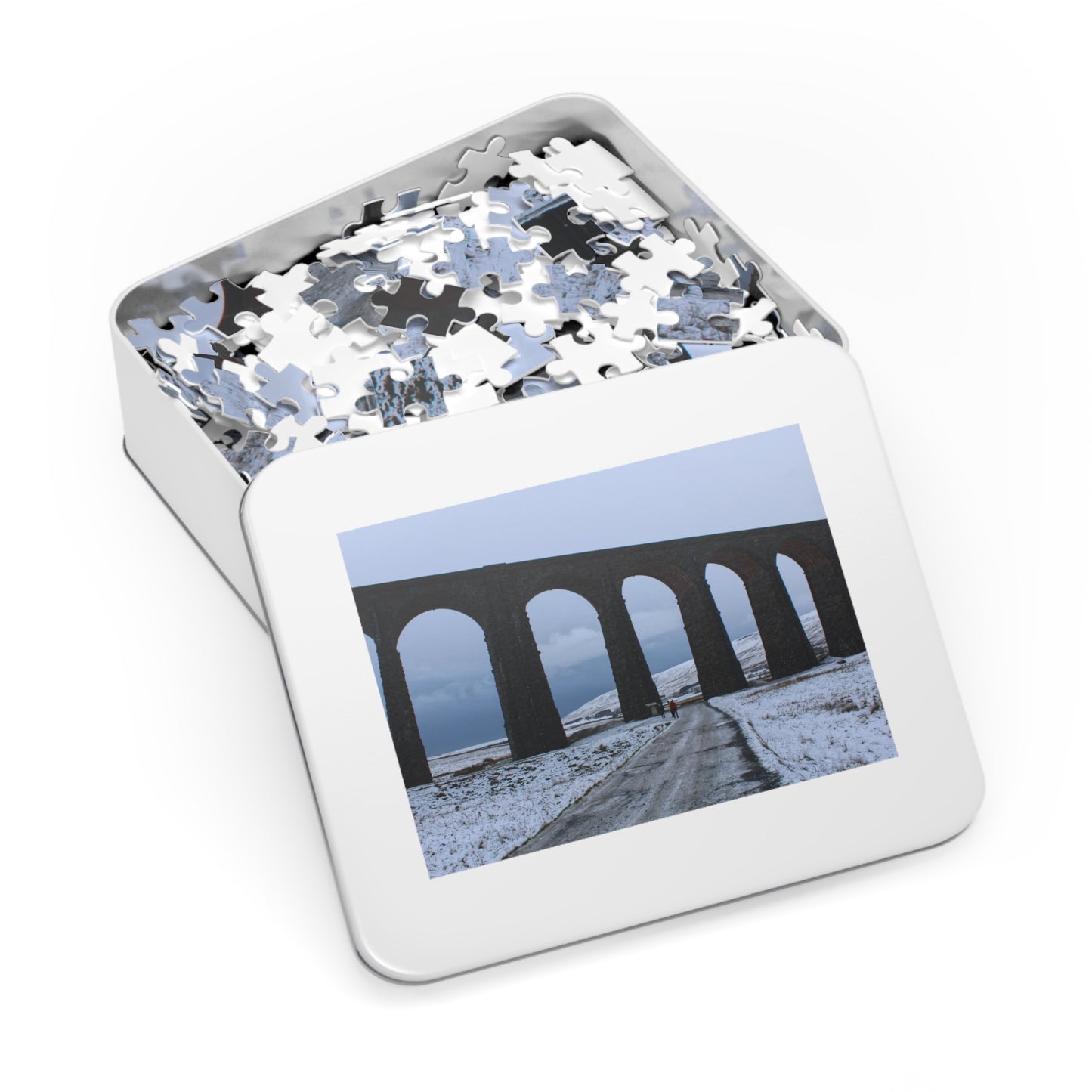 Jigsaw puzzle in a tin with a picture of a viaduct on the lid