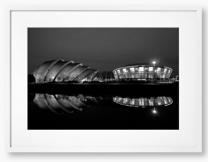 Black and White Framed Photo featuring the Glasgow SEC Armadillo and Hydro buildings lit up at night, reflected in the water of the Clyde.