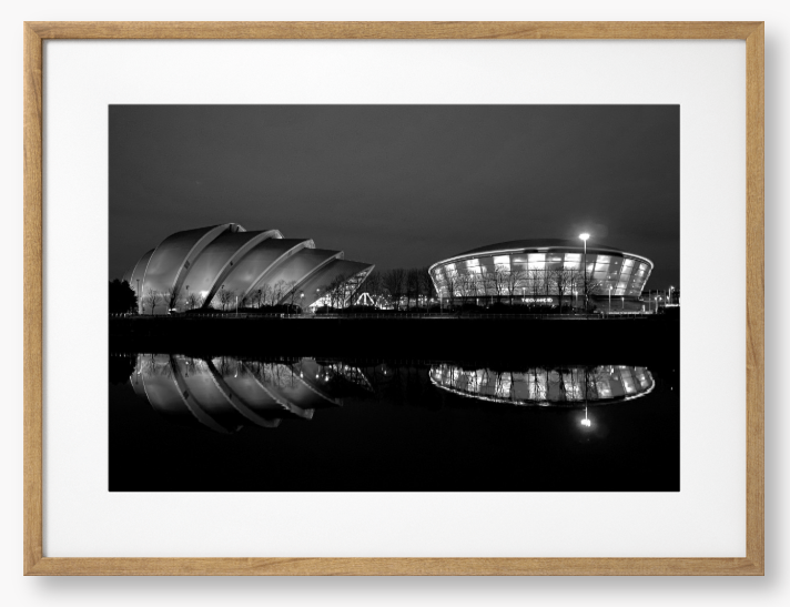 Black and White Framed Photo featuring the Glasgow SEC Armadillo and Hydro buildings lit up at night, reflected in the water of the Clyde.