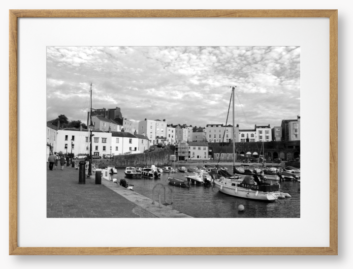 Black and white framed photo of a harbour scene with boats and buildings