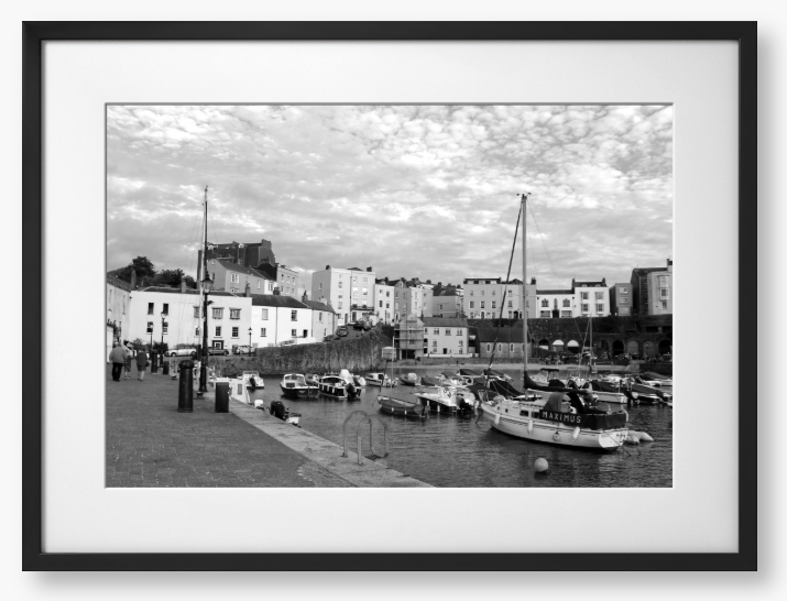 Black and white framed photo of a harbour scene with boats and buildings