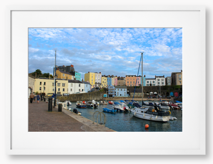 Framed Photo of a Harbour scene with colourful buildings and boats under a blue sky