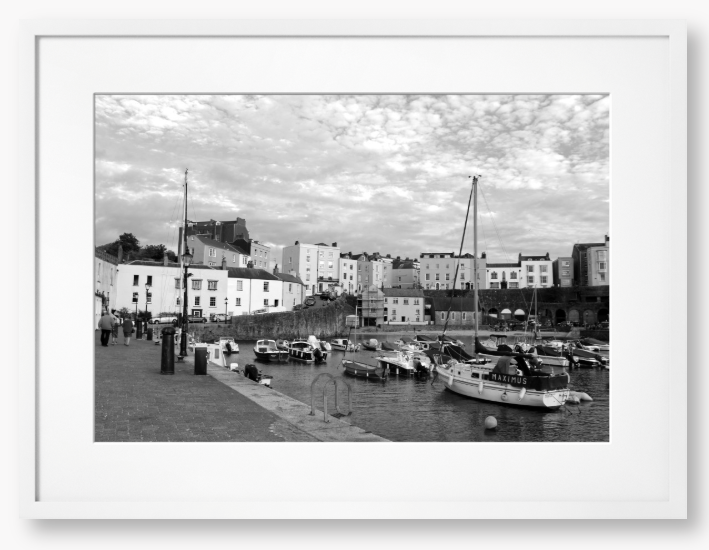 Black and white framed photo of a harbour scene with boats and buildings