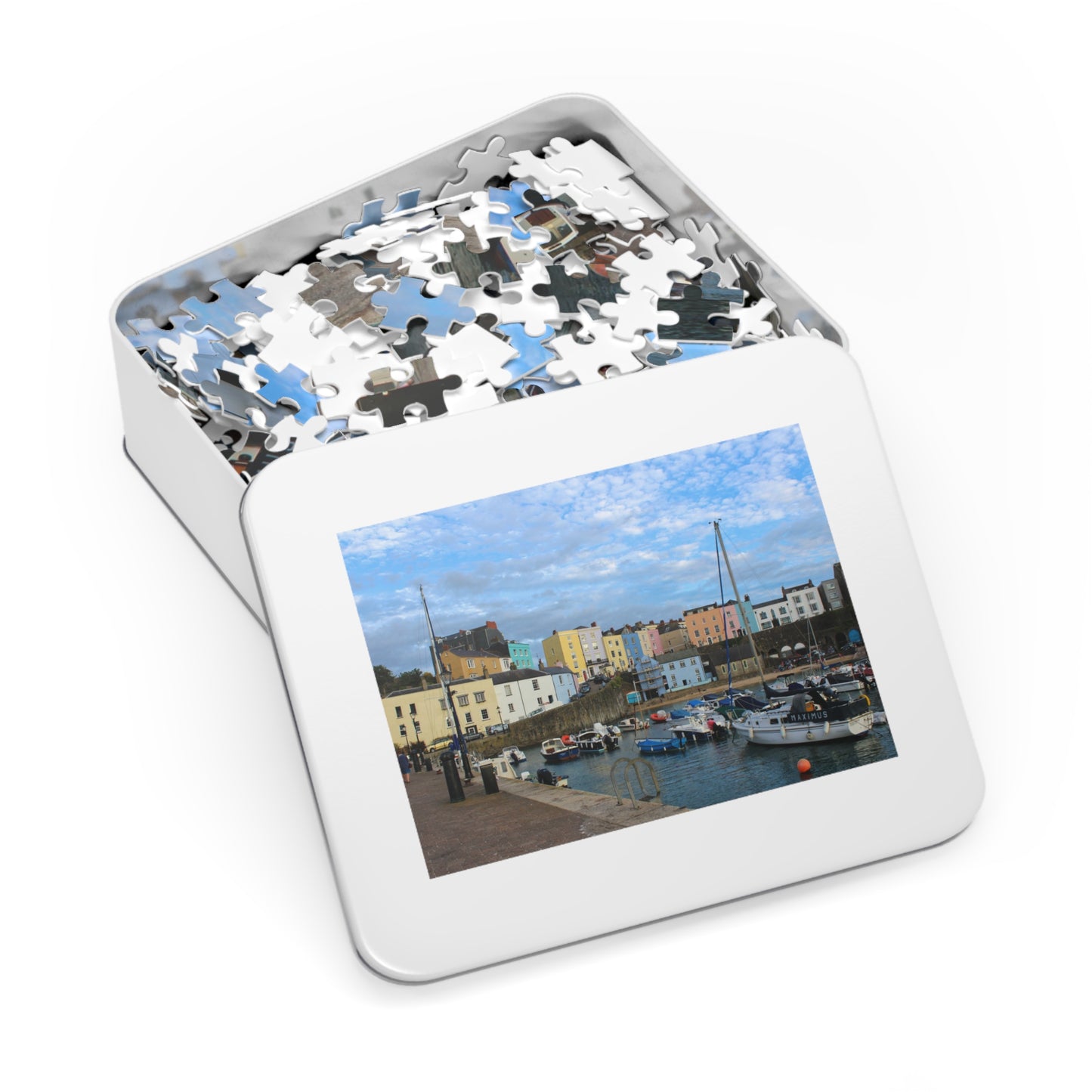 Jigsaw puzzle in a tin with a scenic image of a harbour on the lid