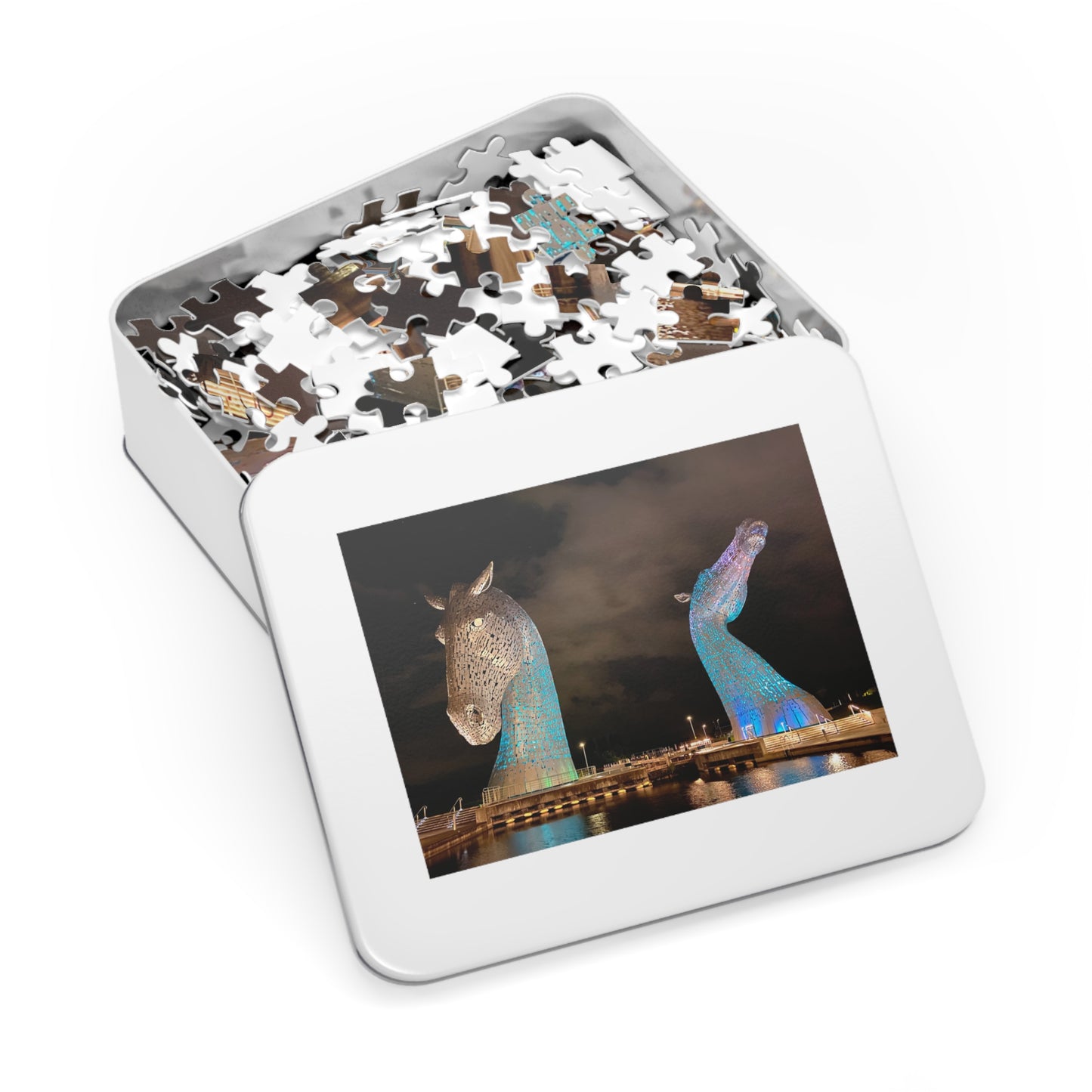 Jigsaw puzzle in a tin box with a picture of two sculptures on the lid