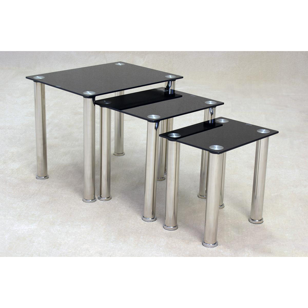 Nest of three tables with black glass tops and chrome stainless steel legs