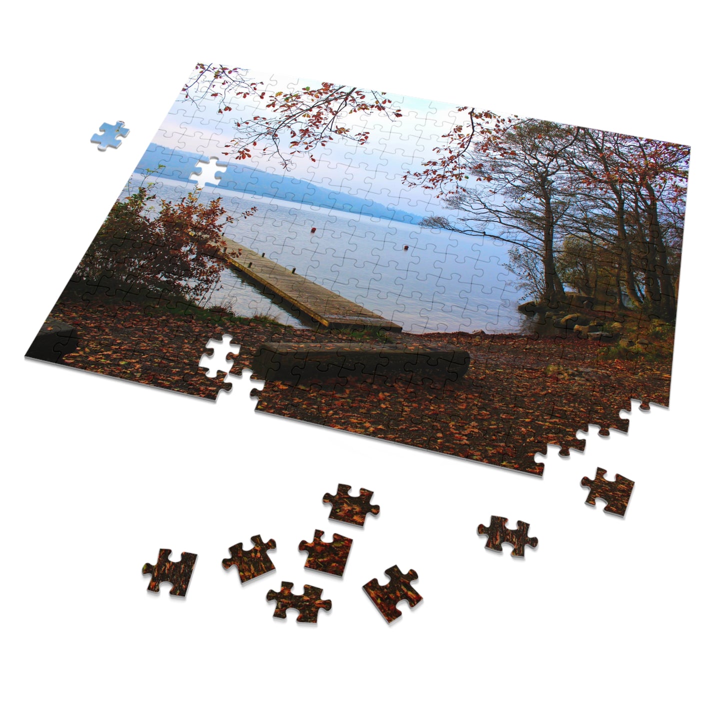 Jigsaw puzzle with a scenic view of a lake and trees, with missing pieces.
