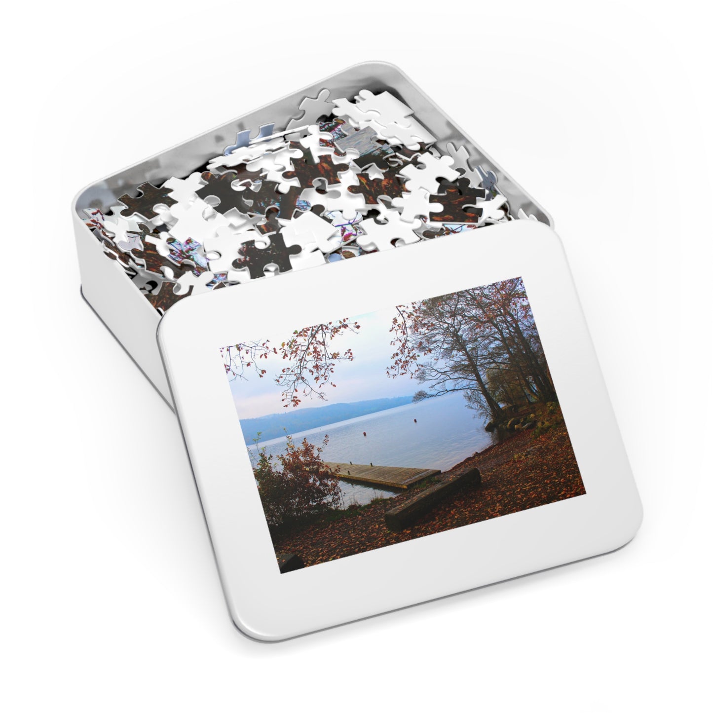 Jigsaw puzzle in a tin box with a scenic image on the lid