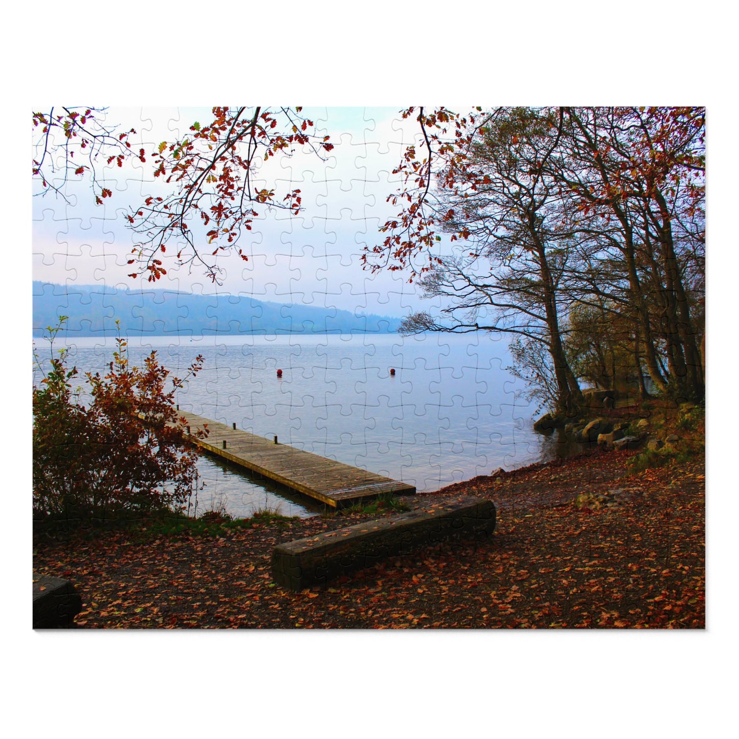 Scenic view of a lake with a wooden dock and autumn foliage.