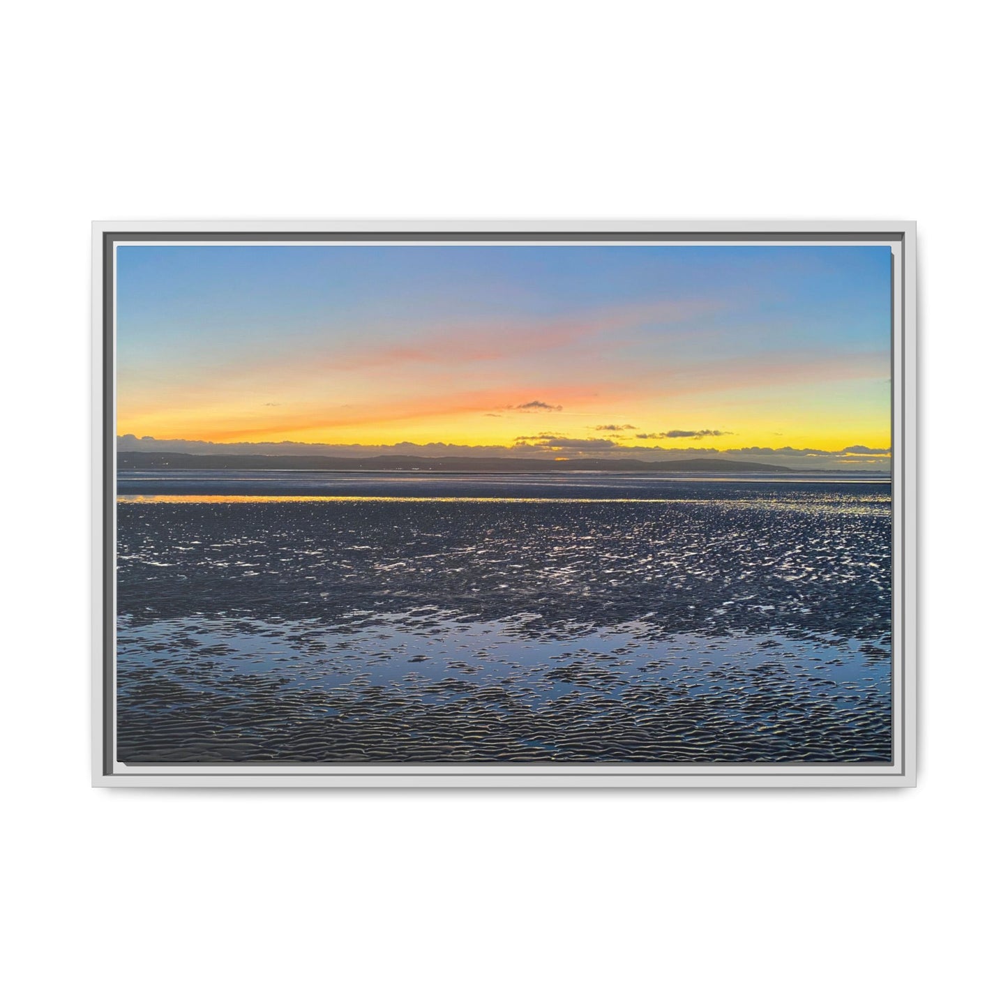 Framed artwork of a sunset over water with a colourful sky.