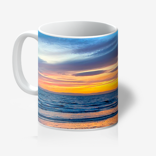 Mug with a sunset over water design on a white background