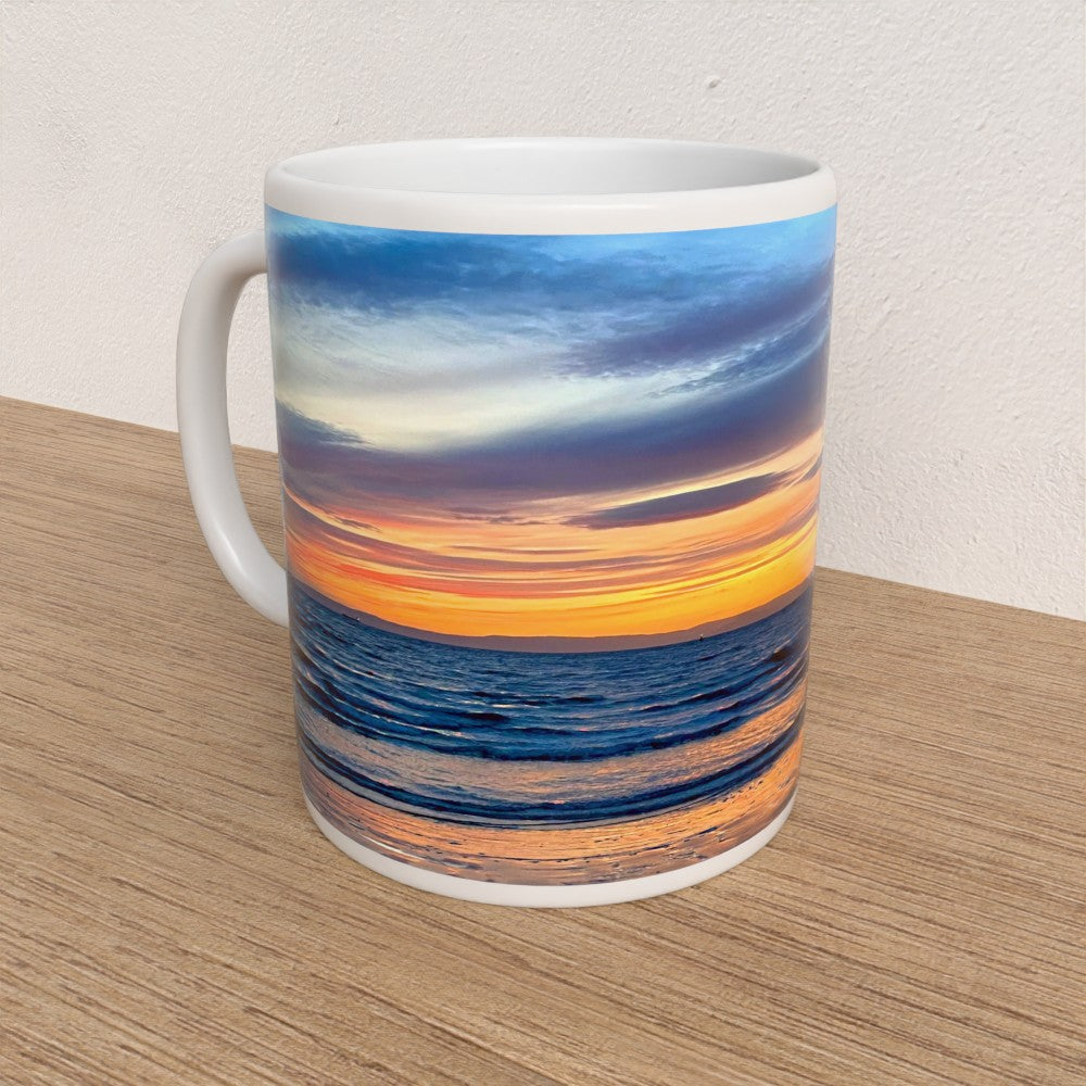 Mug with a sunset design on a wooden surface
