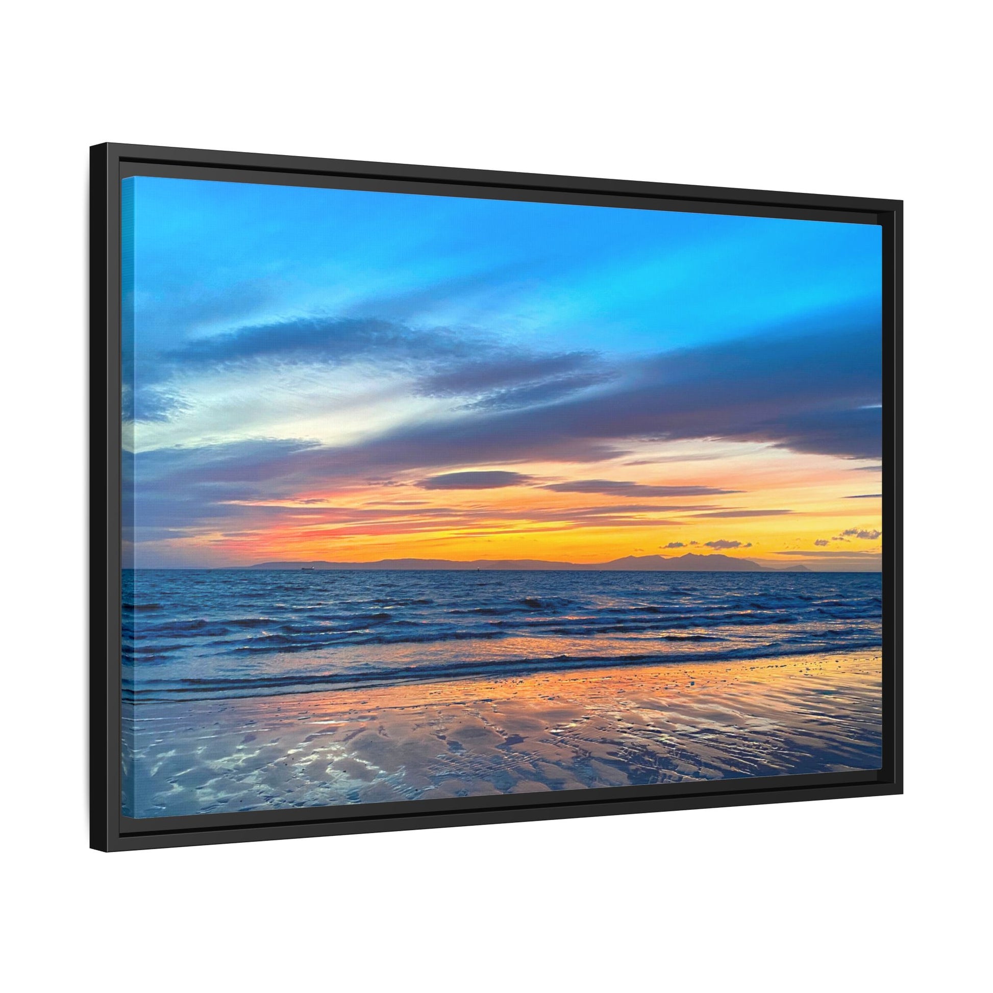 Framed artwork of a sunset over water with a black frame.