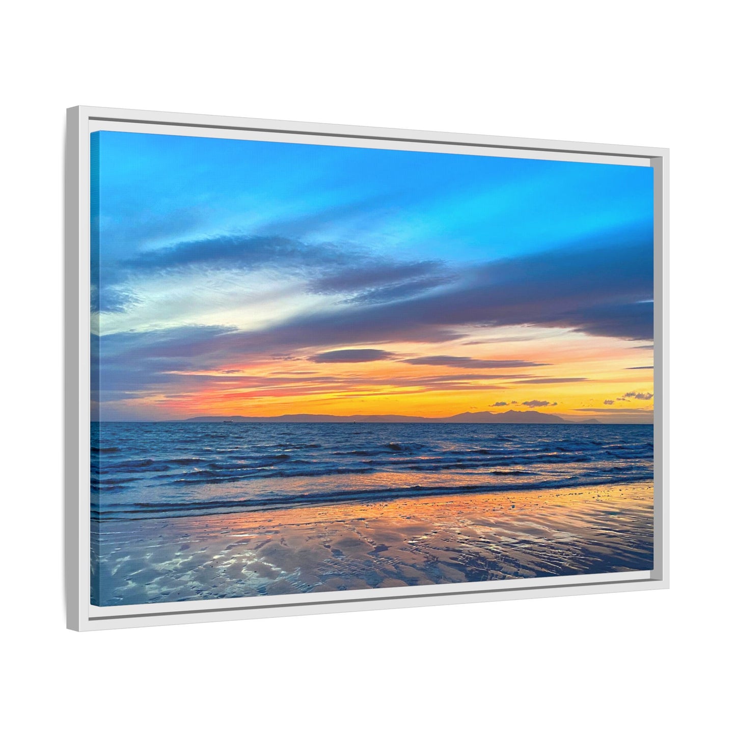 Framed artwork of a sunset over water with a white frame.