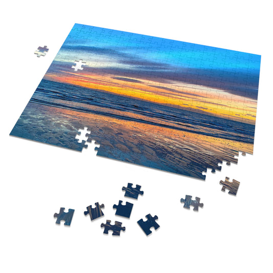 Jigsaw puzzle with a sunset over water design, some pieces missing on a white background