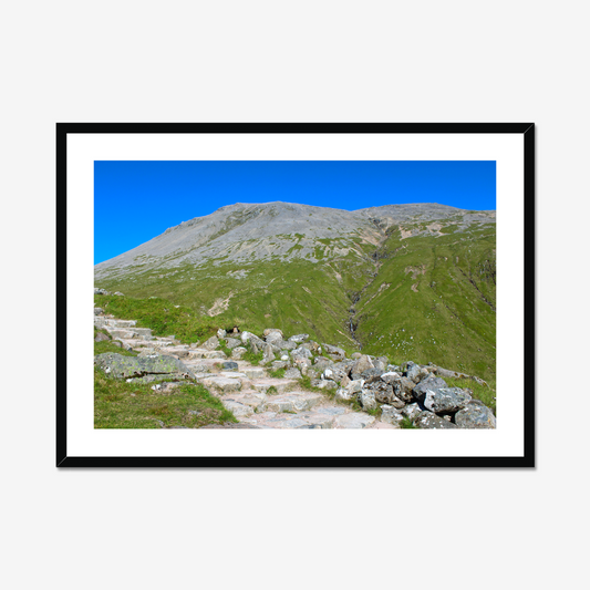 Framed photograph of a mountain landscape with a clear blue sky.
