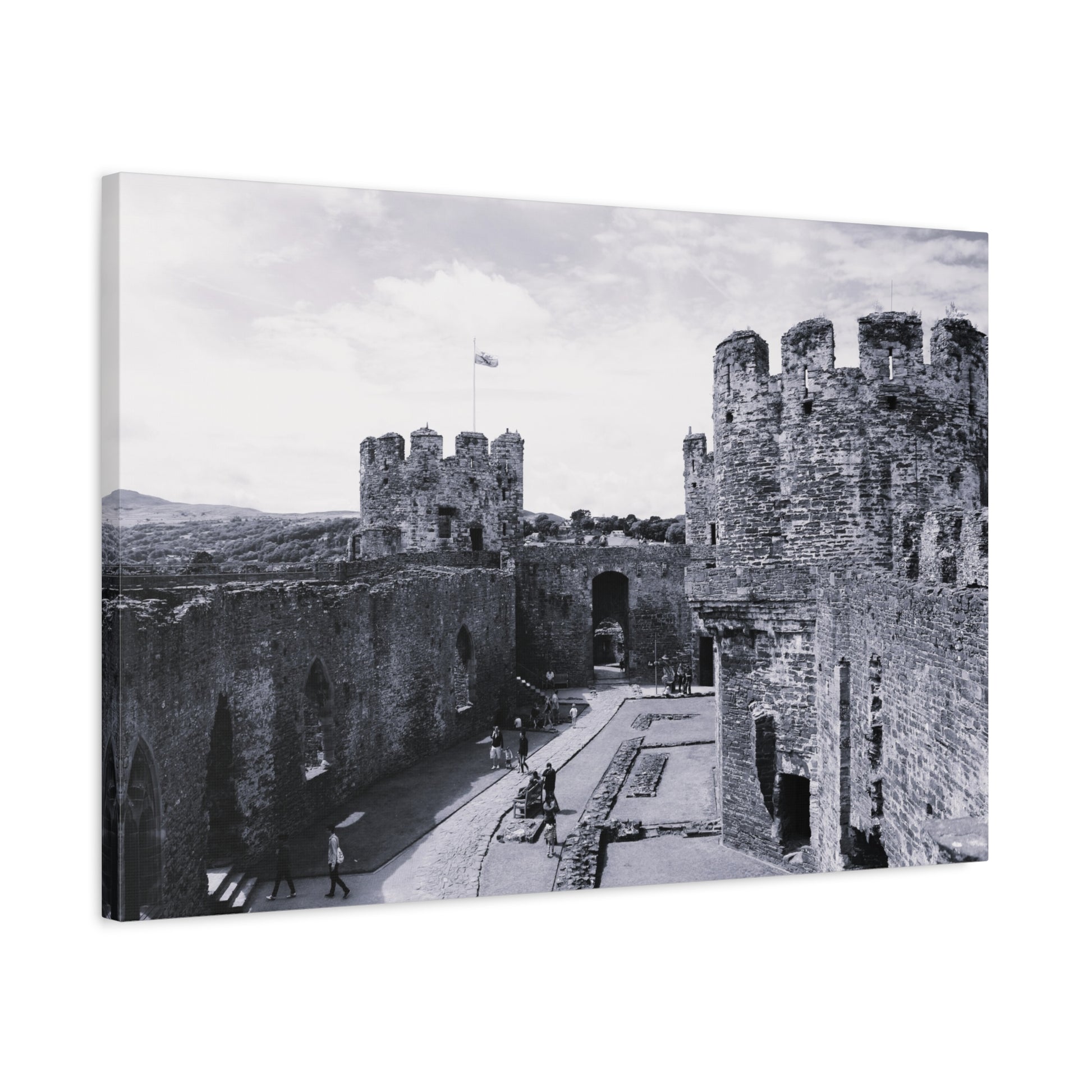 Black and white photograph of a castle with people walking around