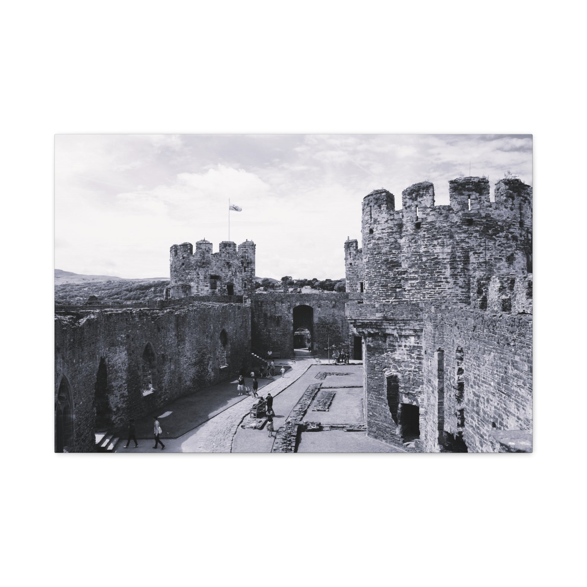 Black and white photo of a castle courtyard with people walking around.
