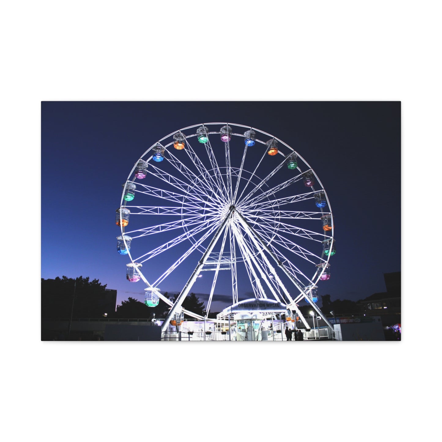 Ferris wheel illuminated at night with a dark sky background