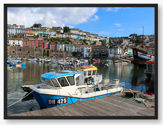 Framed Photo Of A Harbour scene with boats and colourful buildings in the background