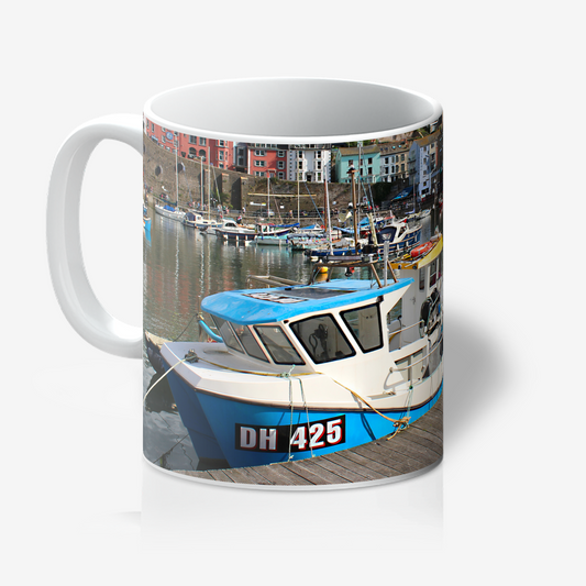 Mug with a boat and harbor scene printed on it