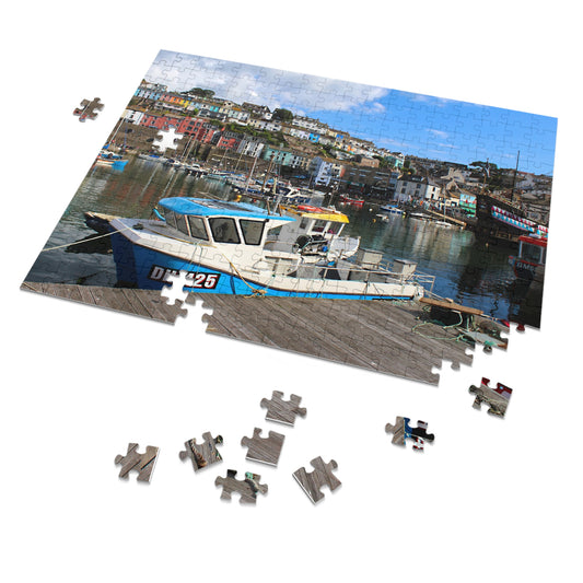 Jigsaw puzzle with a boat in a harbour on a white background