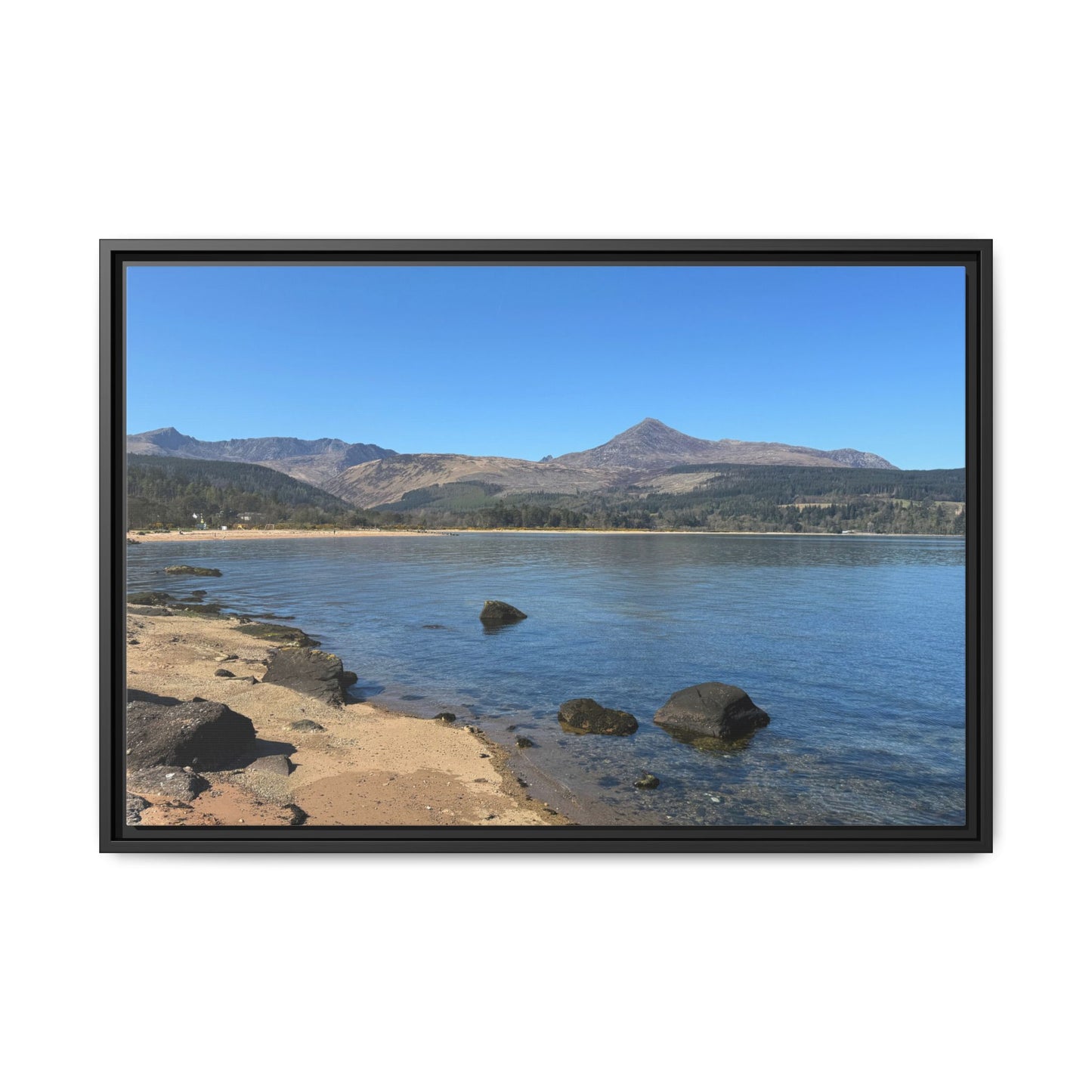 Framed photograph of a lake with mountains in the background