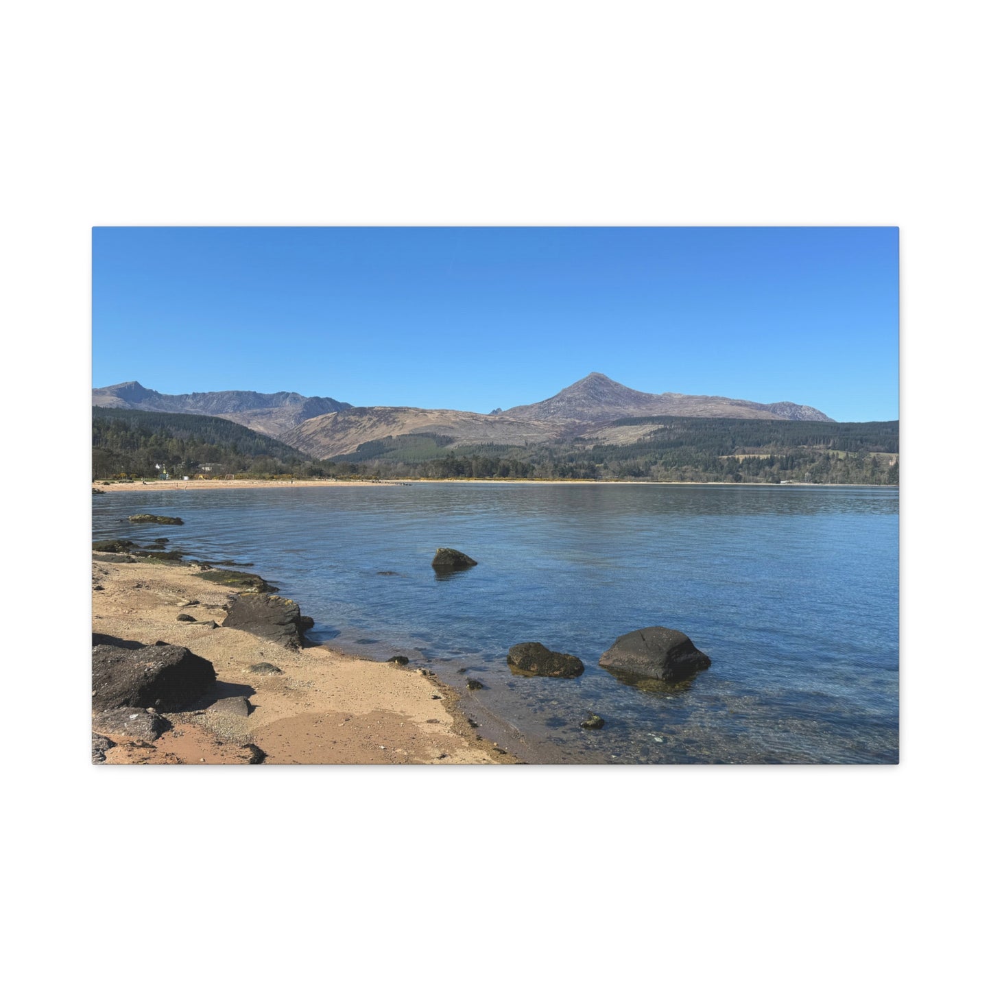 Lakeside scene with mountains in the background
