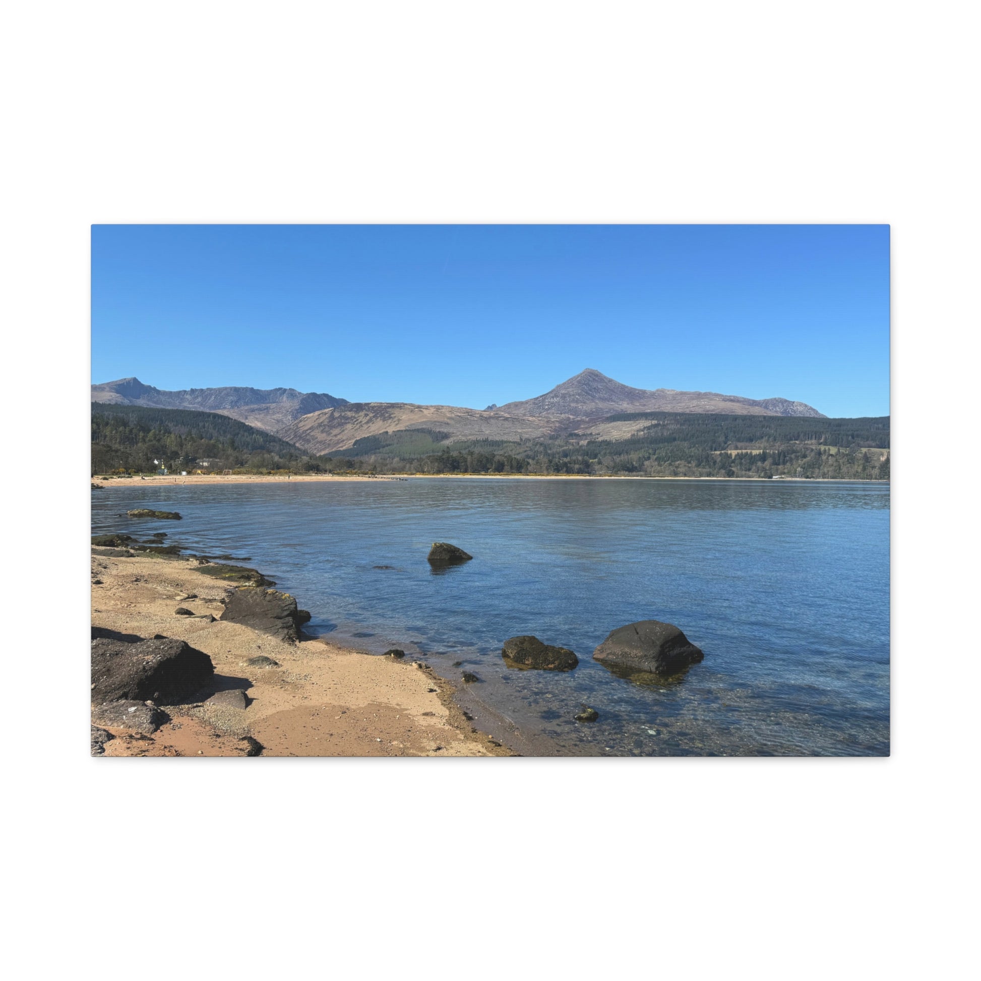 Lakeside scene with mountains in the background