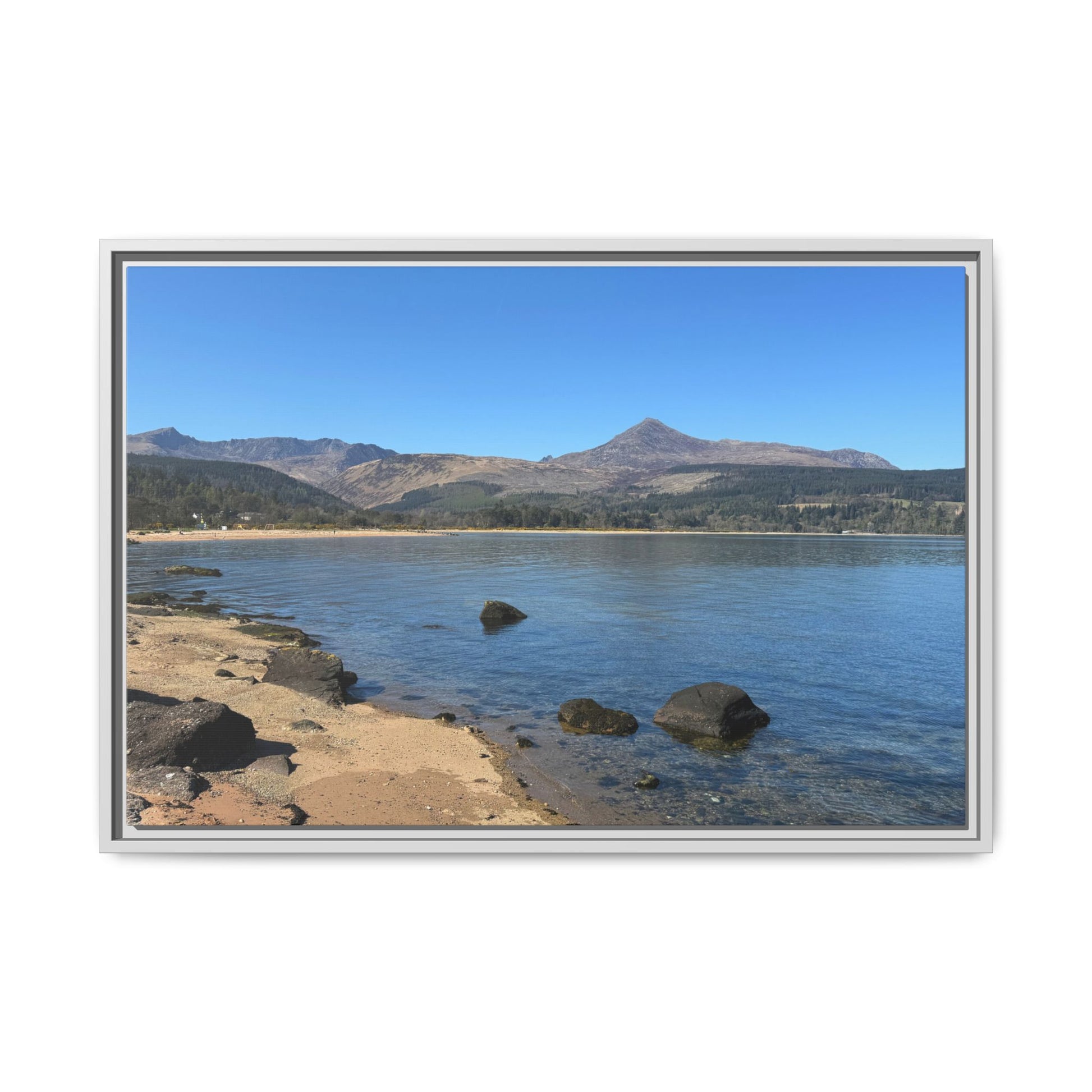 Landscape of a lake with mountains in the background, framed in silver.