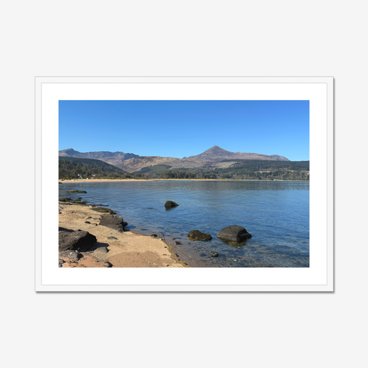 Framed photograph of a coastal scene with mountains in the background