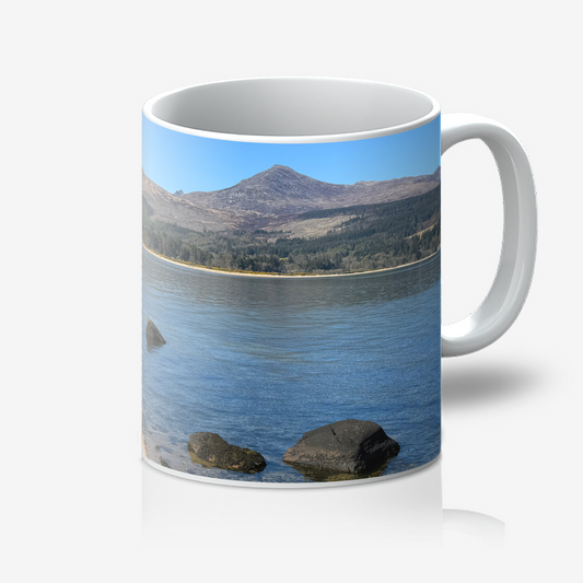 Mug with a scenic design of a lake and mountains on a white background