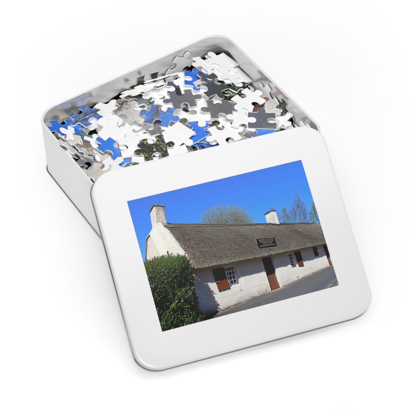 Jigsaw puzzle in a tin with a picture of a house on the lid