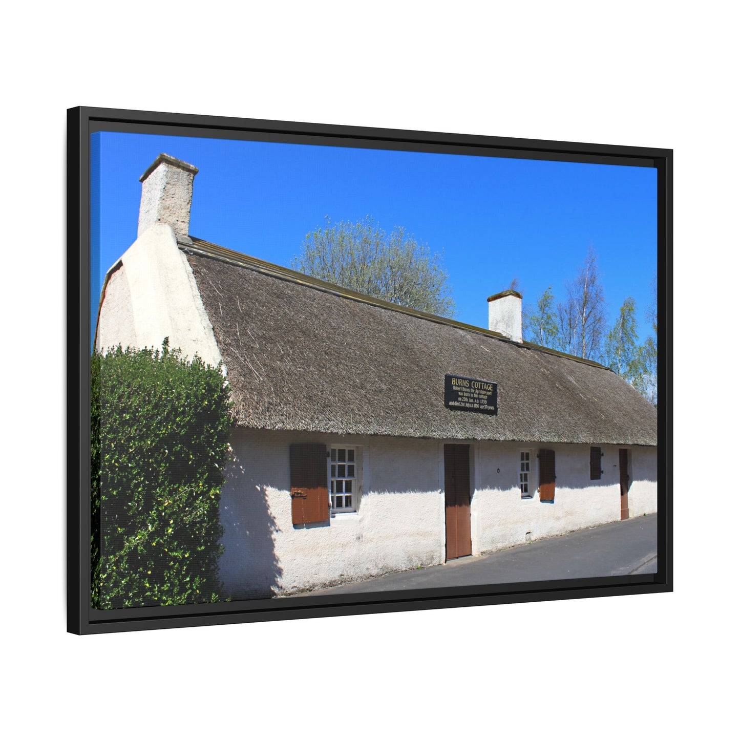 Thatched roof cottage with a clear blue sky in the background