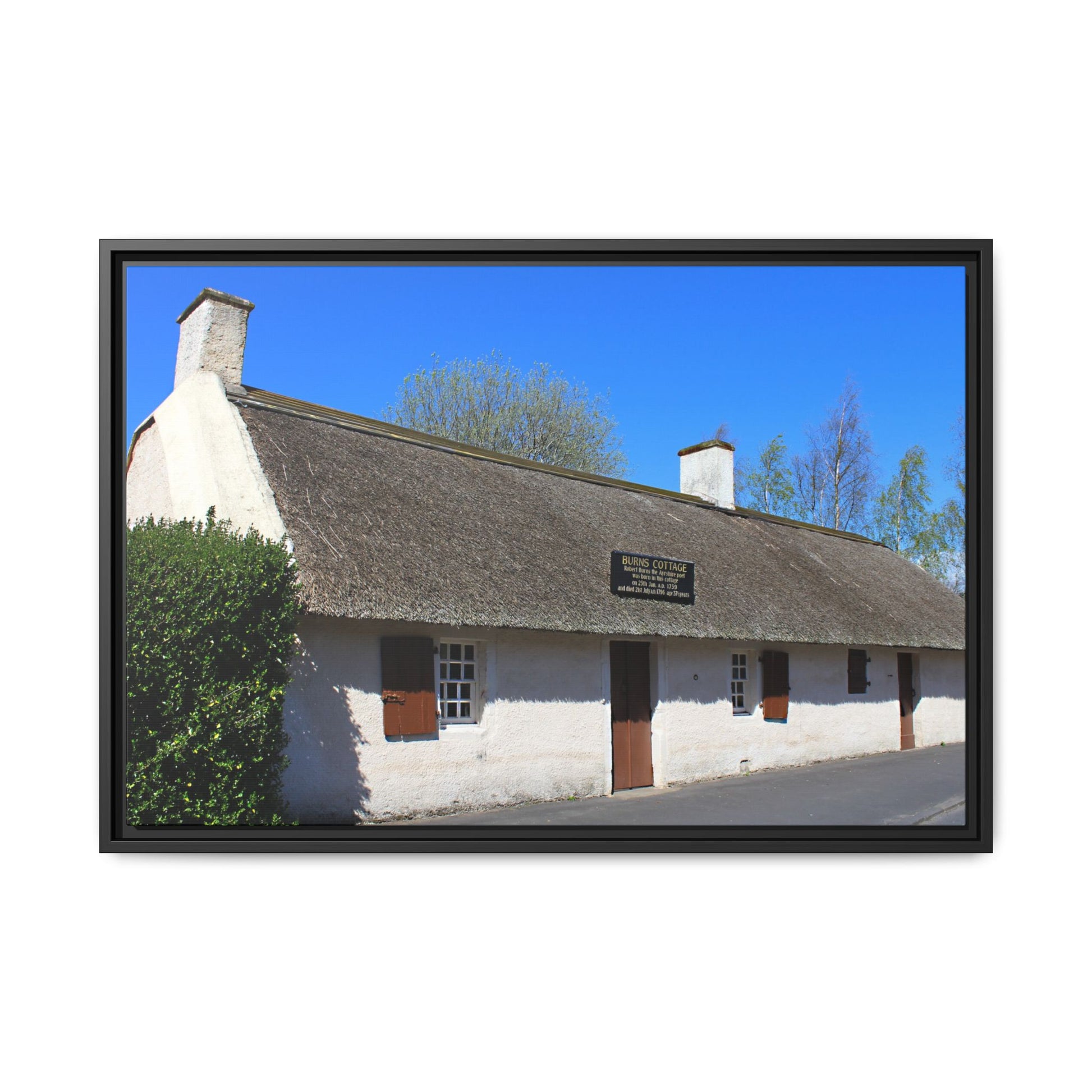 Thatched cottage with a blue sky background