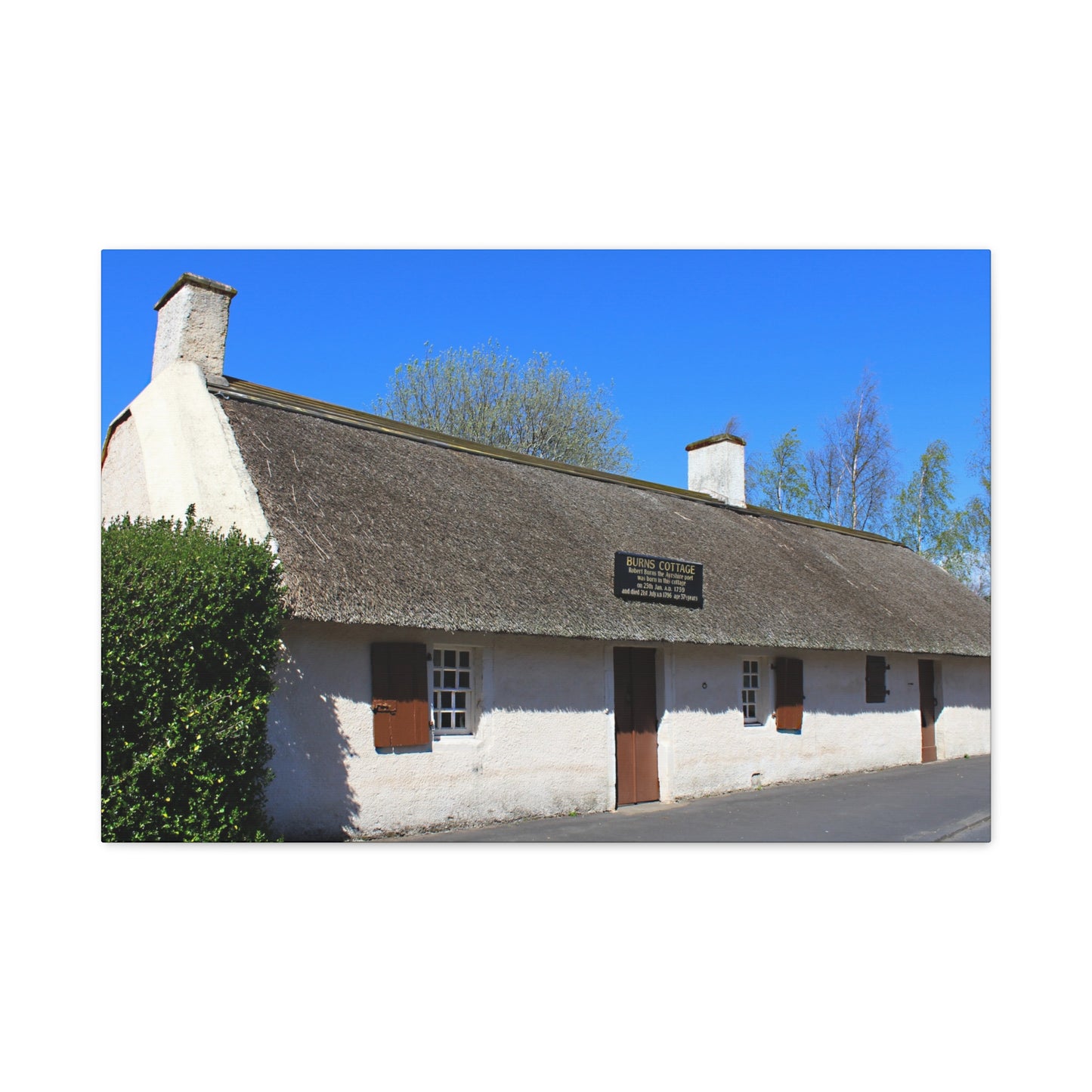 Thatched cottage with a blue sky background