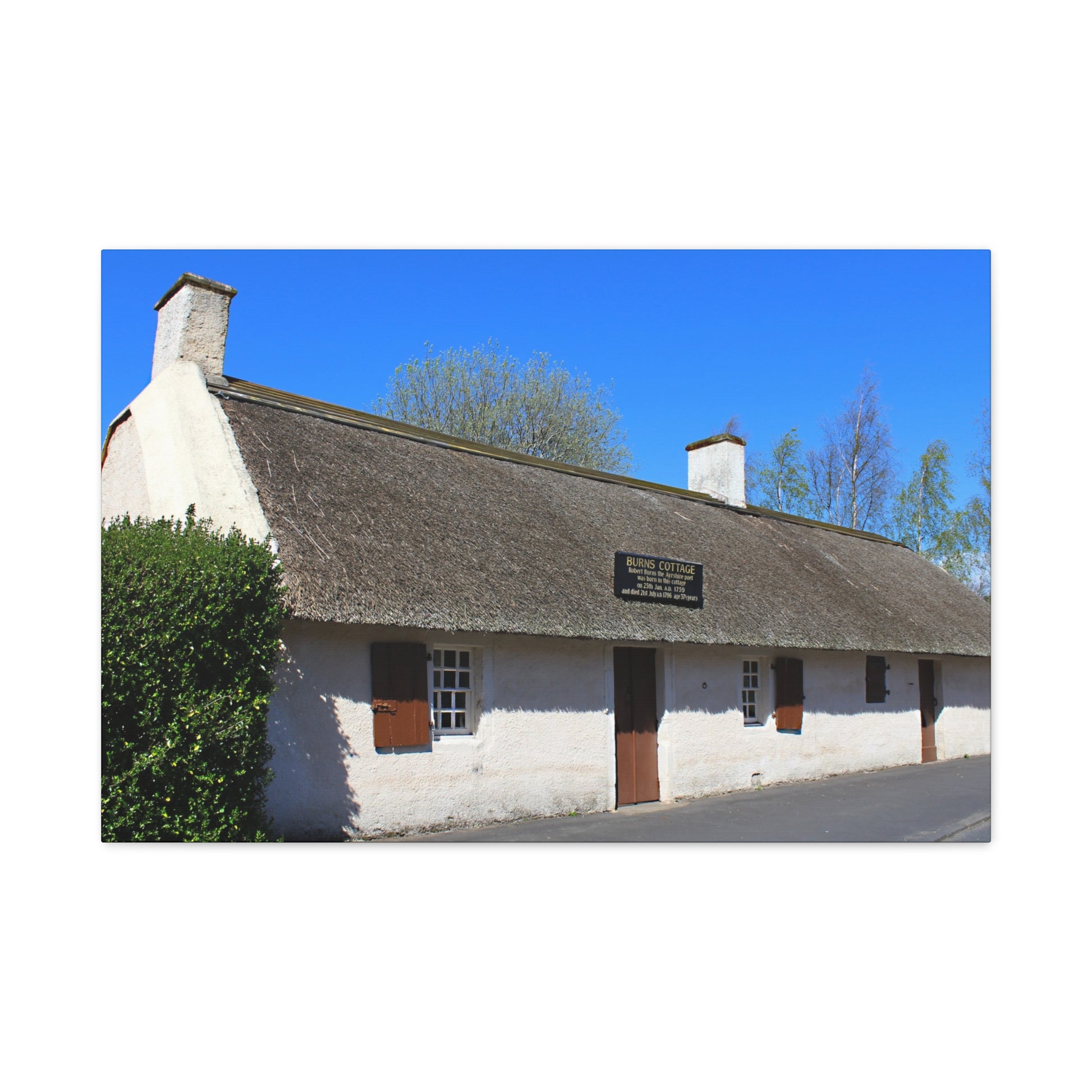 Thatched cottage with a blue sky background