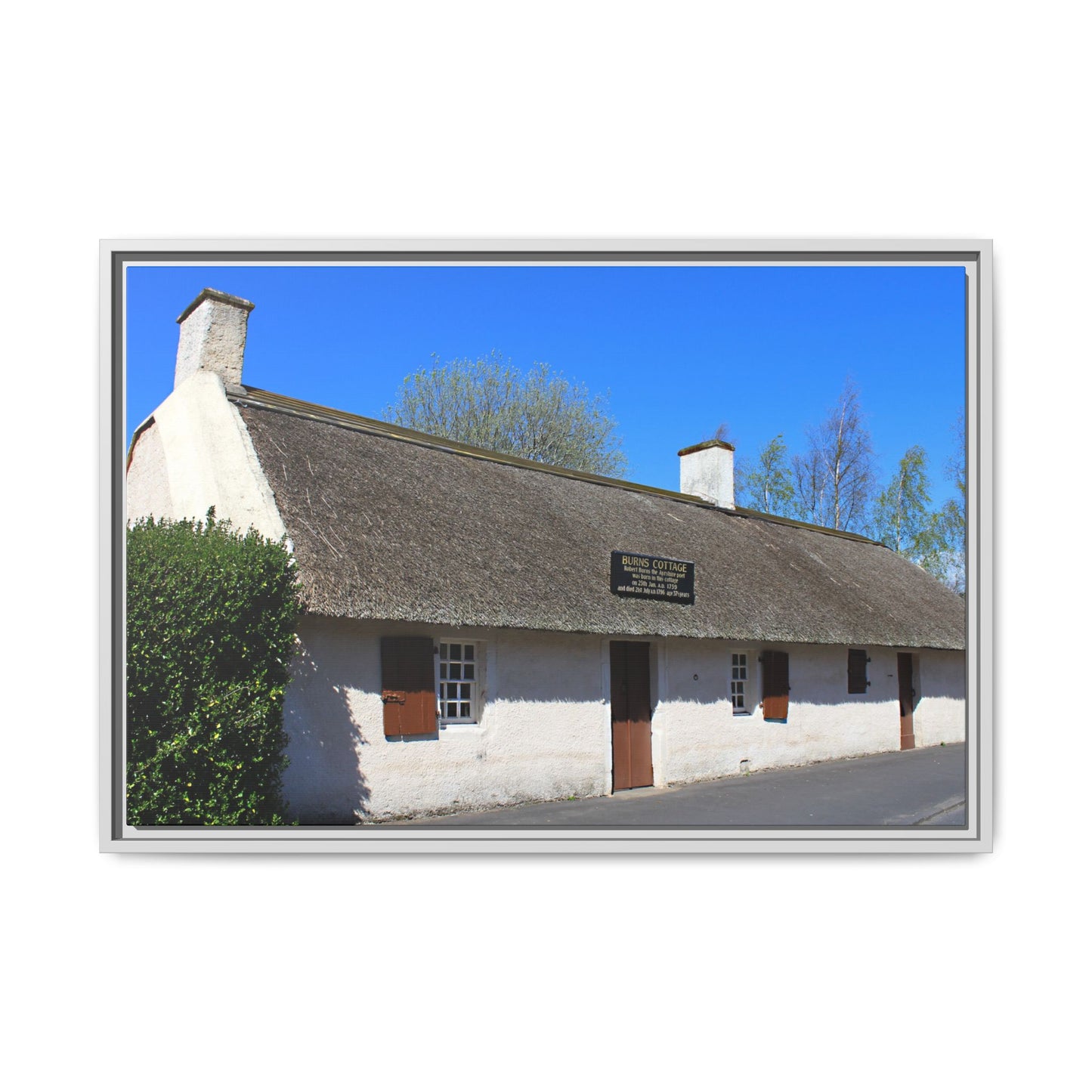 Thatched cottage with a blue sky background
