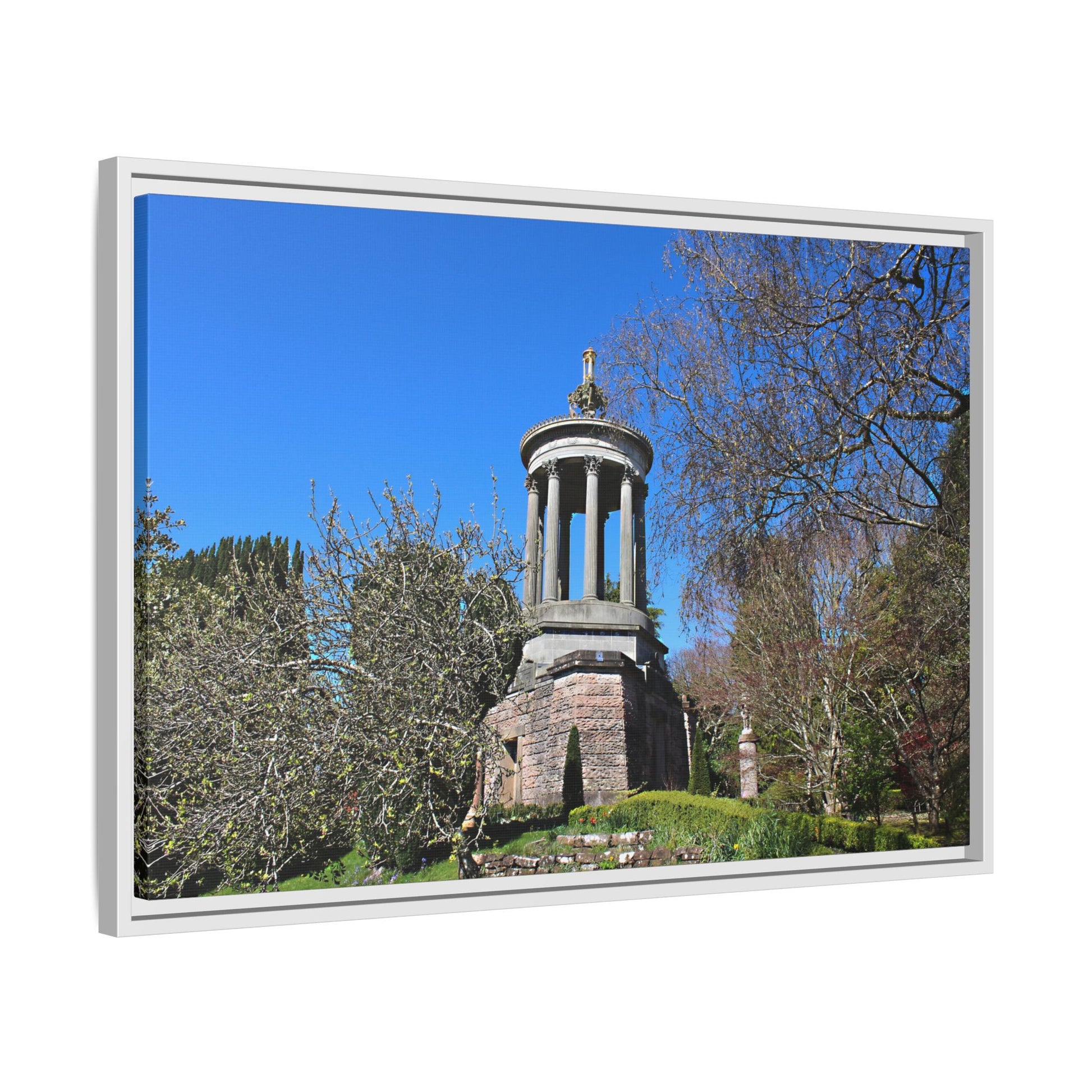 Stone monument with a blue sky and trees in the background