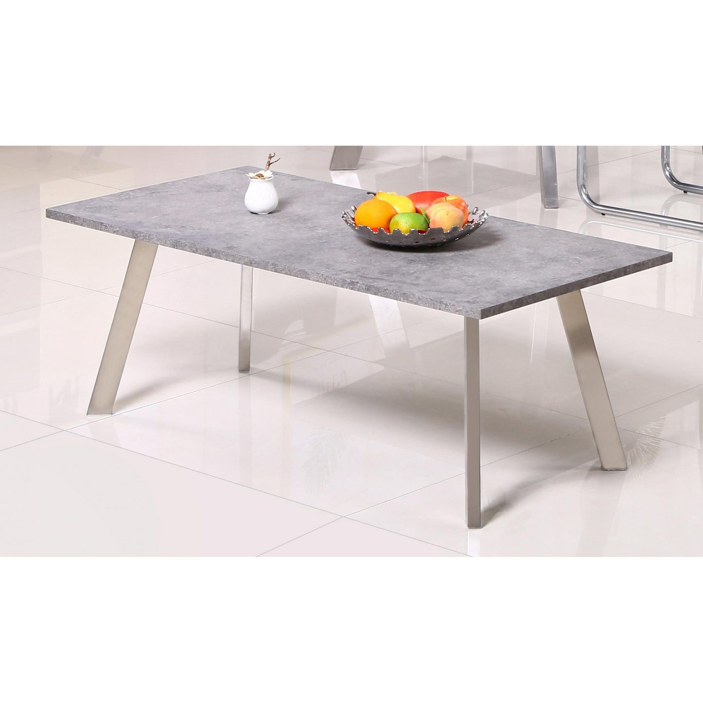 Gray concrete-style table with metal legs on a white floor