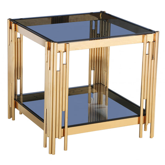 Gold-framed glass table with black top and shelf on a white background