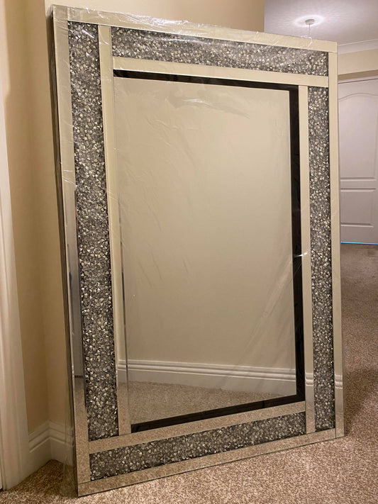 A silver bevelled edge mirror with a crushed crystal design on the frame, measuring 120 x 80 cm, placed against an indoor background.