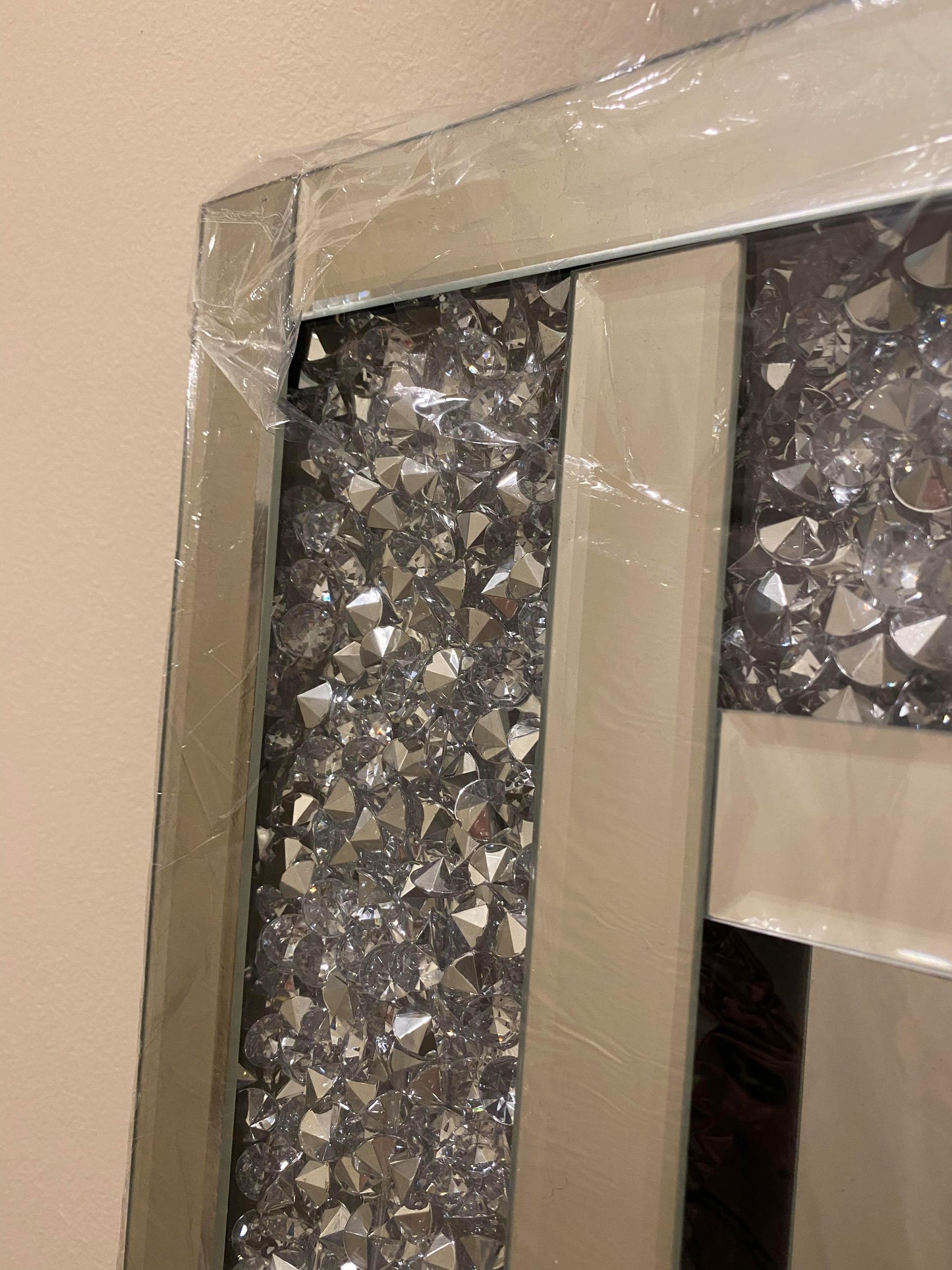 Frame of a bevelled wall mirror with crushed crystals. 