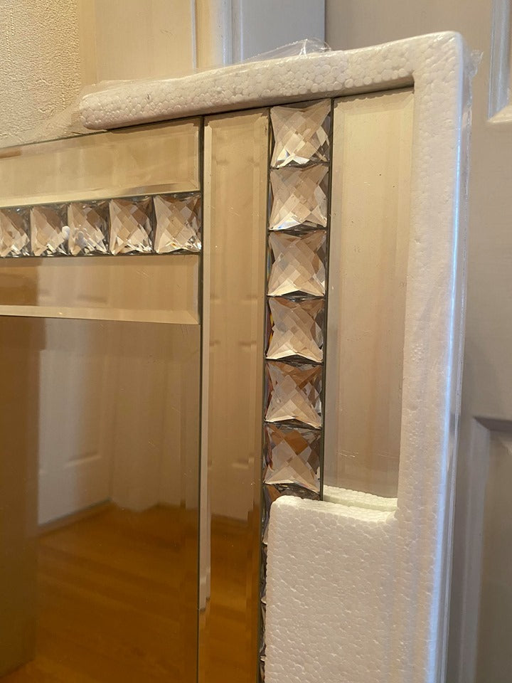 Frame of a bevelled mirror with crystals in it.