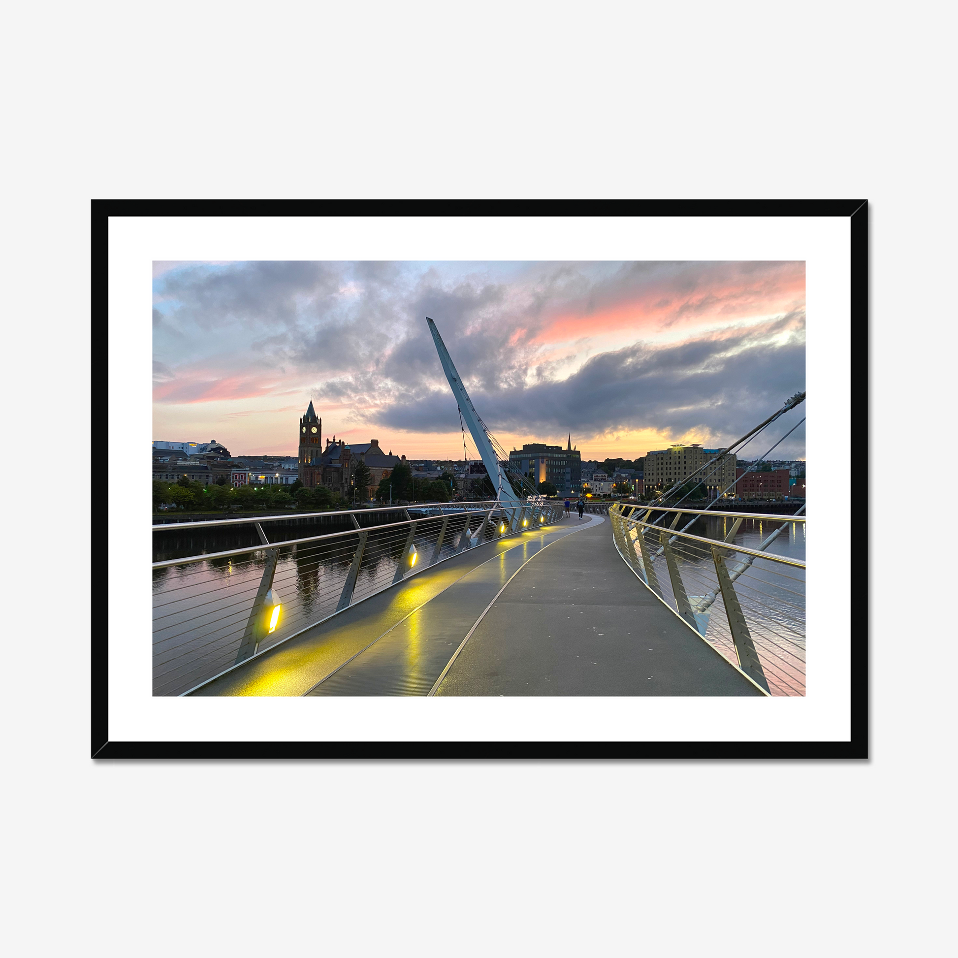 Framed photograph of a cityscape with a modern bridge at sunset.