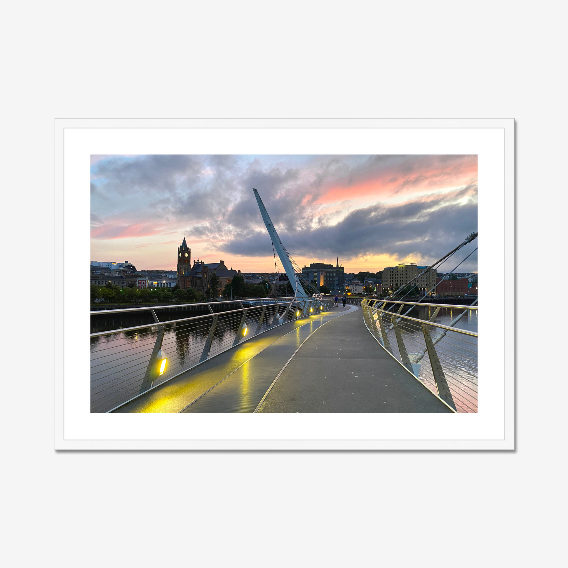 Modern bridge with a cityscape and sunset sky in the background