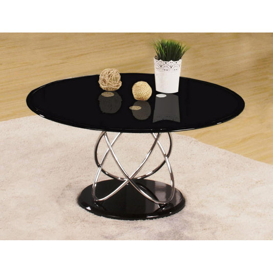 Black glass coffee table with metal base on a beige rug and wooden floor.