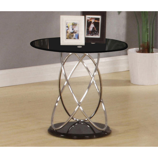 Black glass side table with metal base in a room setting