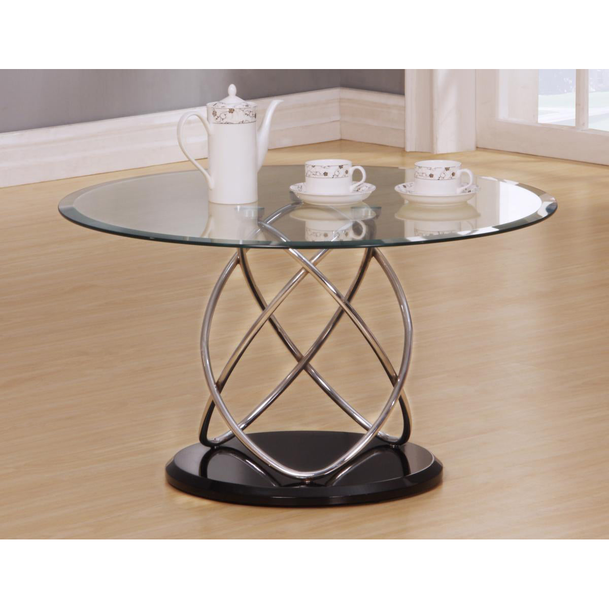 Glass coffee table with metal base on a wooden floor